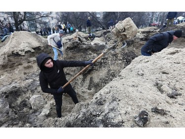 Volunteers dig trenches, as Russia's invasion of Ukraine continues, in Kyiv, March 3, 2022.