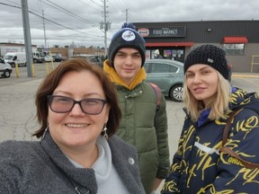 Real estate agent Alexandra Botyuk (left) gives Aleksii and his mother Olena Dnistrianska, of Kyiv, Ukraine, a tour of Toronto after meeting on Wednesday, March 23, 2022.