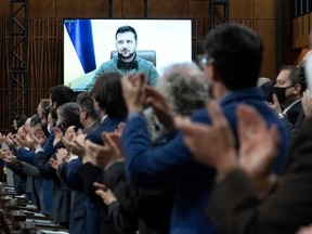 MPs applaud Ukrainian President Volodymyr Zelenskyy in the House of Commons on March 15, 2022.