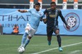 New York City defender Thiago Martins (top) battles for the ball against Philadelphia Union forward Sergio Santos.