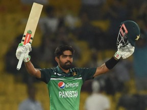 Pakistan's captain Babar Azam celebrates after scoring a century (100 runs) during the third and final one-day international (ODI) cricket match between Pakistan and Australia at the Gaddafi Cricket Stadium in Lahore on April 2, 2022.