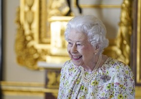 Queen Elizabeth II smiles as she arrives to view a display of artefacts from British craftwork company, Halcyon Days, to commemorate the company’s 70th anniversary, in the White Drawing Room at Windsor Castle, March 23, 2022. (Steve Parsons/WPA Pool/Getty Images)