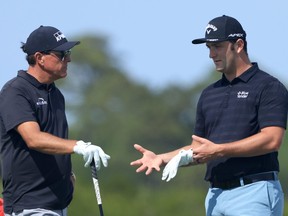 Phil Mickelson of the United States, left, talks with Jon Rahm of Spain during a practice round prior to the 2021 PGA Championship at Kiawah Island Resort's Ocean Course on May 17, 2021 in Kiawah Island, South Carolina.