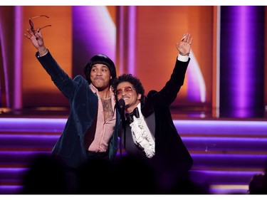 LAS VEGAS, NEVADA - APRIL 03: (L-R) Anderson .Paak and Bruno Mars of Silk Sonic accept the Record Of The Year award for 'Leave The Door Open' onstage during the 64th Annual GRAMMY Awards at MGM Grand Garden Arena on April 03, 2022 in Las Vegas, Nevada.