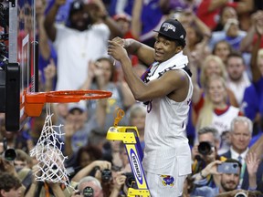 David McCormack #33 of the Kansas Jayhawks cuts down the net after defeating the North Carolina Tar Heels 72-69 during the 2022 NCAA Men's Basketball Tournament National Championship at Caesars Superdome on April 04, 2022 in New Orleans, Louisiana.