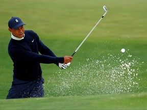 Tiger Woods warms up on the range during a practice round prior to the Masters at Augusta National Golf Club on Tuesday.