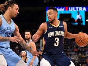 CJ McCollum of the New Orleans Pelicans handles the ball against Brandon Clarke of the Memphis Grizzlies during the second half at FedExForum on April 09, 2022 in Memphis, Tennessee.