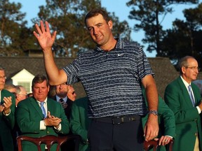 Scottie Scheffler waves to the crowd during the Green Jacket Ceremony after winning the Masters at Augusta National Golf Club on April 10, 2022 in Augusta, Georgia.