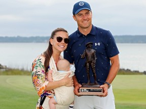 Jordan Spieth poses with the trophy with wife Annie Verret and son Sammy Spieth after winning the RBC Heritage in a playoff at Harbor Town Golf Links on April 17, 2022 in Hilton Head Island, South Carolina.
