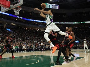 Giannis Antetokounmpo #34 of the Milwaukee Bucks is fouled by DeMar DeRozan #11 of the Chicago Bulls during the second half of Game One of the Eastern Conference First Round Playoffs at Fiserv Forum on April 17, 2022 in Milwaukee, Wisconsin.