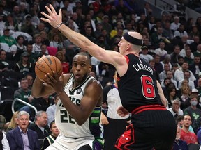 Khris Middleton #22 of the Milwaukee Bucks is defended by Alex Caruso #6 of the Chicago Bulls in the second half of Game Two of the Eastern Conference First Round Playoffs at Fiserv Forum on April 20, 2022 in Milwaukee, Wisconsin.
