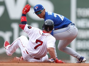 Christian Vazquez #7 of the Boston Red Sox is tagged out by Gosuke Katoh #29 of the Toronto Blue Jays during the fifth inning at Fenway Park on April 21, 2022 in Boston, Massachusetts.
