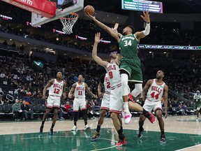 Giannis Antetokounmpo #34 of the Milwaukee Bucks drives to the basket against Nikola Vucevic #9 of the Chicago Bulls in the third quarter during Game Five of the Eastern Conference First Round Playoffs at Fiserv Forum on April 27, 2022 in Milwaukee, Wisconsin.