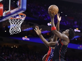 Toronto Raptors' OG Anunoby goes up for a layup against Tyrese Maxey of the Philadelphia 76ers.
