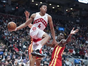 Raptors forward Scottie Barnes (4) controls the ball as Atlanta Hawks center Clint Capela (15) tries to defend during the fourth quarter on Tuesday.