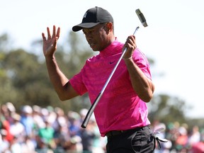 Tiger Woods of the U.S. acknowledges patrons on the 18th green after finishing the first round at the Masters on Thursday. Tiger finished the round at one under.