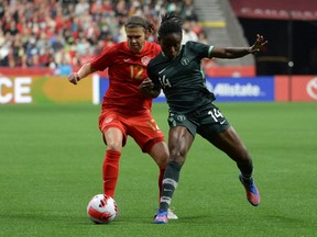 Canadian forward Christine Sinclair (12) challenges Women's Nigeria National Christy Onyenaturuchi Ucheibe (14) during the first half at BC Place on April 8, 2022. The two teams faced each other again in Langford, B.C., playing to a 2-2 tie on April 11, 2022.