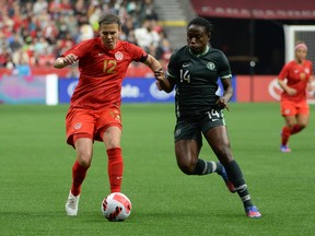 Canadian forward Christine Sinclair (12) challenges Women's Nigeria National Christy Onyenaturuchi Ucheibe (14) during the first half at BC Place on April 8, 2020.