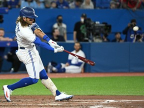 Toronto Blue Jays shortstop Bo Bichette (11) hits a solo home run against the Texas Rangers in the fifth inning at Rogers Centre on Saturday. The Jays won 4-3.