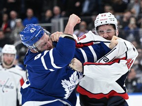 Maple Leafs forward Kyle Clifford (43) fights with Washington Capitals forward Tom Wilson (43) in the second period at Scotiabank Arena.