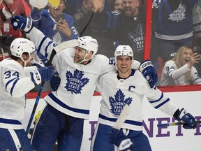 Maple Leafs defenceman Mark Giordano his overtime goal with with Auston Matthews and center John Tavares last night at the Canadian Tire Centre in Ottawa.