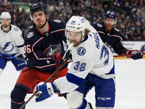 Blue Jackets' Jack Roslovic high-sticks Lightning's Brandon Hagel last night in Columbus. A 5-2 Tampa loss plus a Bruins win over Buffalo on Thursday means the playoff matchup for the Leafs won't be decided until Friday night.