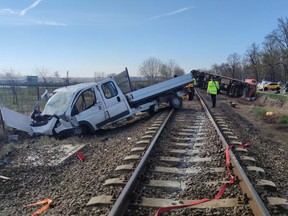 A derailed train and a pick-up truck are seen at a scene of an accident where the pick-up truck crashed into the train in Mindszent, Hungary, April 5, 2022.