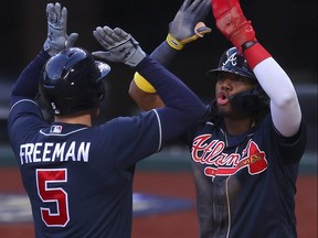 Freddie Freeman of the Atlanta Braves is congratulated by Ronald Acuna Jr. after hitting a two run home run against the Los Angeles Dodgers during the fourth inning in Game Two of the National League Championship Series at Globe Life Field on Oct. 13, 2020 in Arlington, Texas.