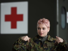 A picture taken on March 22, 2020 in Biere, western Switzerland shows sergeant Gabrielle Ramseier gestures during a formation before being deployed to support public hospitals as part of a historic mobilisation for Swiss Army since the Second World War, against the spread of the COVID-19, the novel coronavirus.