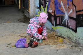 A picture taken on April 23, 2022 shows a child living in a large underground parking lot in Kharkiv, eastern Ukraine, during the Russian invasion of Ukraine. (Photo by SERGEY BOBOK/AFP via Getty Images)