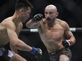 Alexander Volkanovski of Australia punches Chan Sung Jung of South Korea during the featherweight title bout in the UFC 273 event at VyStar Veterans Memorial Arena on April 9, 2022 in Jacksonville, Fla.