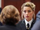 Actor Amber Heard speaks with her legal team as she attends Johnny Depp's defamation trial against her at the Fairfax County Circuit Courthouse in Fairfax, Virginia, April 13, 2022.