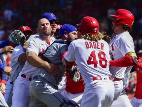 Benches clear as St. Louis Cardinals designated hitter Nolan Arenado (28) reacts with New York Mets catcher Tomas Nido (3) and relief pitcher Yoan Lopez (44) after a high and tight pitch during the eighth inning at Busch Stadium in St. Louis, Miss., April 27, 2022.