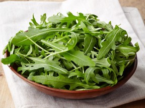 Bowl of fresh arugula leaves