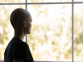 Thoughtful woman with cancer going through hard treatment