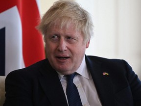 Britain's Prime Minister Boris Johnson reacts as he meets with Ghana's President Nana Akufo-Addo in London, Tuesday, April 5, 2022.