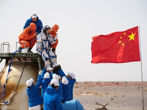 Rescue workers carry Chinese astronaut Wang Yaping out of a return capsule after three astronauts returned to earth following the Shenzhou-13 manned space mission to complete construction of the space station, at the Dongfeng landing site in Inner Mongolia Autonomous Region, China April 16, 2022.