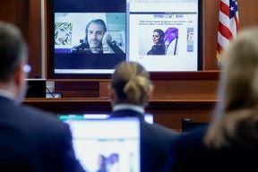 Actor Johnny Depp watches a pre-recorded deposition testimony of Christian Carino during Depp's defamation trial against his ex-wife Amber Heard, at the Fairfax County Circuit Courthouse in Fairfax, Va., April 27, 2022.
