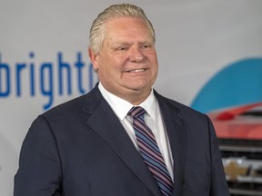 Ontario Premier Doug Ford listens during an announcement at General Motors Canada’s Canadian Technical Centre,  McLaughlin Advanced Technology Track in Oshawa on Monday April 4, 2022.