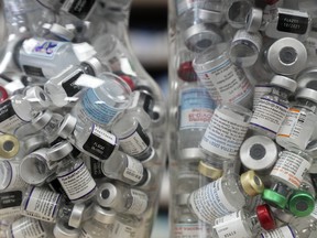 Jars full of empty COVID-19 vaccine vials are shown at the Junction Chemist pharmacy during the COVID-19 pandemic in Toronto on Wednesday, April 6, 2022.