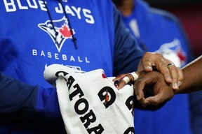 A trainer helps Toronto Blue Jays first baseman Vladimir Guerrero Jr., right, who suffered an injury during the second inning of the team’s baseball game against the New York Yankees on Wednesday, April 13, 2022, in New York. (AP Photo/Frank Franklin II)