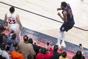 Philadelphia 76ers center Joel Embiid celebrates after scoring a game-winning three-pointer as Toronto Raptors guard Fred VanVleet watches during NBA playoff first round play of overtime on Wednesday, April 20, 2022 in Toronto .