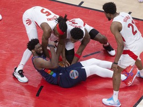 Raptors’ Precious Achiuwa, OG Anunoby and Thad Young gang up on Sixers star Joel Embiid during yesterday’s 110-102 Game 4 victory at Scotiabank Arena.