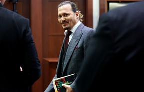 Johnny Depp smiles in a courtroom in Virginia.