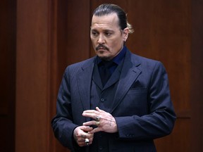 Johnny Depp stands during a break in his defamation trial against his ex-wife Amber Heard, at the Fairfax County Circuit Courthouse in Virginia.