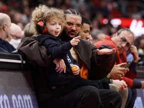 Rapper Drake and his son Adonis take in the Game 6 of the Eastern Conference First Round between the Toronto Raptors and the Philadelphia 76ers at Scotiabank Arena on April 28, 2022.
