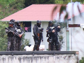 Riot police agents shoot tear gas into the CRS Turi prison after a riot in Cuenca, Ecuador, on April 3, 2022.
