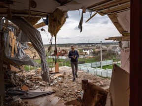 Local resident Oksana walks through the destroyed second floor of her multi-generational home while searching for salvageable items on April 25, 2022 in Gostomel, Ukraine.