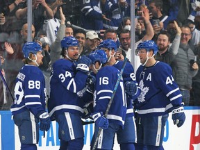 Auston Matthews #34 of the Toronto Maple Leafs celebrates his 60th goal of the season with teammates during an NHL game against the Detroit Red Wings at Scotiabank Arena on April 26, 2022 in Toronto, Ontario, Canada. The Maple Leafs defeated the Red Wings 3-0. (Photo by Claus Andersen/Getty Images)