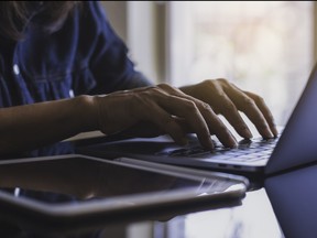 A senior uses a laptop.